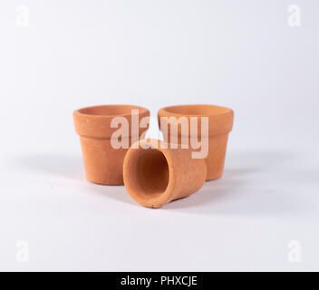 Set of three empty terracotta pots isolated on white. Stock Photo