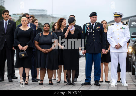 Members of the McCain family watch joint service members of a military casket team carry the casket of Senator John McCain from the US Capitol to a motorcade that will ferry him to a funeral service at the National Cathedral in Washington, DC, USA, 01 September 2018. McCain died 25 August, 2018 from brain cancer at his ranch in Sedona, Arizona, USA. He was a veteran of the Vietnam War, served two terms in the US House of Representatives, and was elected to five terms in the US Senate. McCain also ran for president twice, and was the Republican nominee in 2008. Credit: Jim LoScalzo/Pool via C Stock Photo