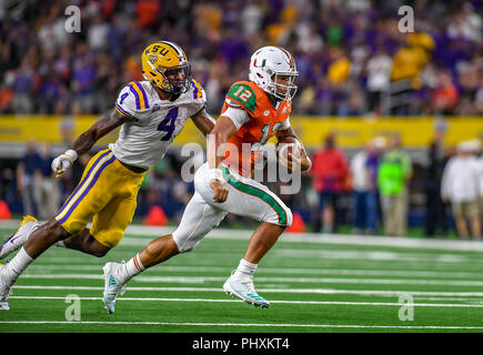 September 2, 2018: Miami Hurricanes running back DeeJay Dallas #13 is hit  as he carries the ball in the Advocare Classic NCAA Football game between  the University of Miami Hurricanes and the