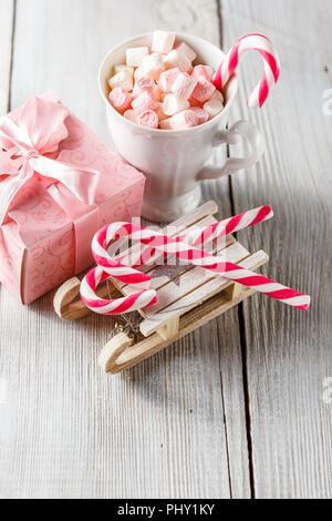 Christmas cup with small marshmallows and candy canes Stock Photo