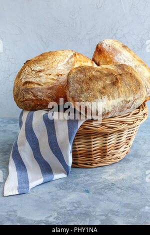 Freshly baked artisanal bread in the basket. Stock Photo