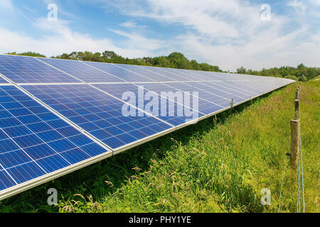 Long diagonal row of blue solar panels Stock Photo