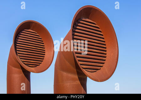 Two brown metal pipes for air outlet in Algarve Portugal Stock Photo