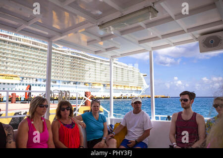 Cozumel, Mexico - May 04, 2018: tourists on ferry boat in blue caribbean water at Cozumel, Mexico Stock Photo