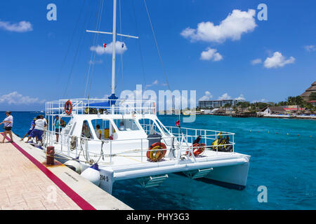 Cozumel, Mexico - May 04, 2018: tourists on ferry boat in blue caribbean water at Cozumel, Mexico Stock Photo