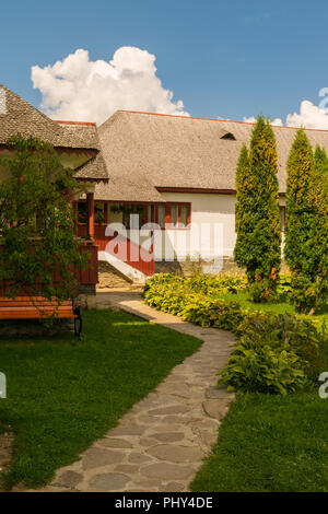 rock slab pavement alley in garden leading to house building Stock Photo