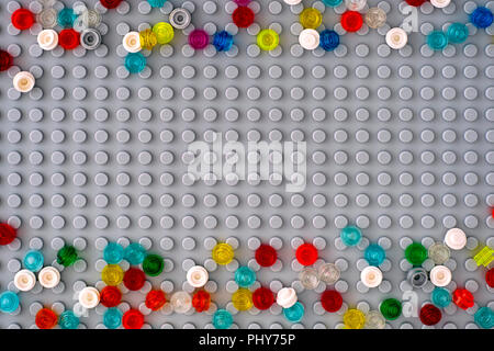 Tambov, Russian Federation - September 02, 2018 Lego gray baseplate with scattered Round Bricks 1x1. Studio shot. Stock Photo