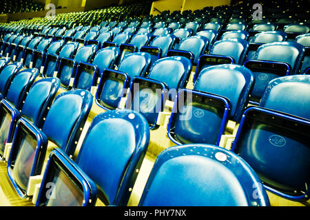 rows of empty blue seats in a stadium Stock Photo
