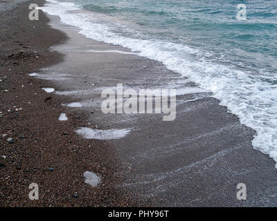 The black sand beach at Wadi Qandil. Mediterranean Sea, Syria. Stock Photo