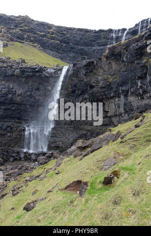 Tourist at the Fossa Waterfall on island Bordoy in the Faroe Islands ...