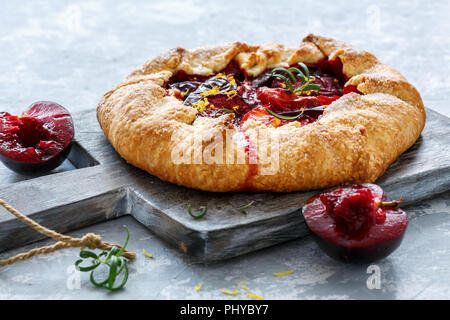 Homemade pies (Galette) with yellow and red plums. Stock Photo