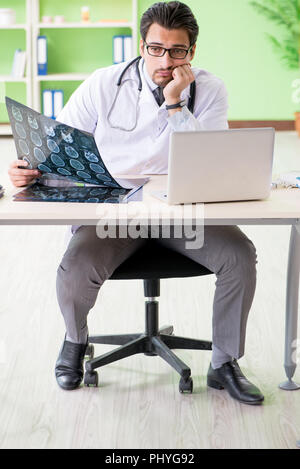 Doctor radiologist looking at x-ray scan in hospital Stock Photo