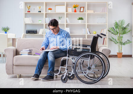 Young student on wheelchair in disability concept Stock Photo