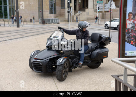 Owner driving her Can-Am’s Spyder F3 Limited Delta trikes motorcycle with two front wheels and one drive wheel on the back Stock Photo