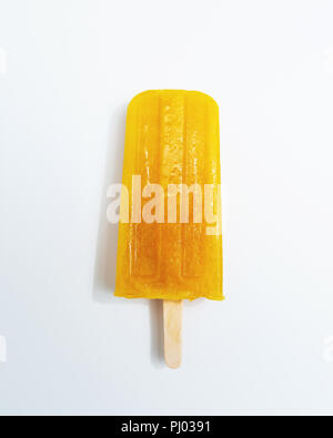 Ice lollies. Orange fruit ice cream presented on a white background with copy space. Top view Stock Photo