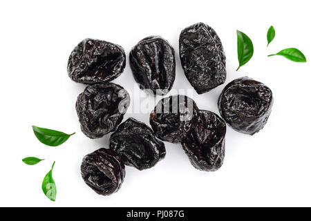 Dried plum - prunes decorated with green leaves isolated on a white background. Top view. Flat lay. Stock Photo