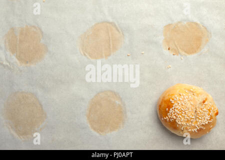 Homemade burger bun on bakery parchment . Food photography, concept of homemade fresh bakery. Rolls with sesame seeds hamburger with sesame, pumpkin,  Stock Photo