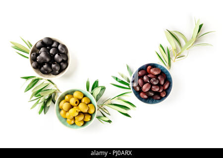 Overhead photo of various olives in bowls on white with copy space Stock Photo