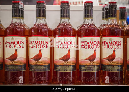 London, UK - August 12, 2018 - Bottles of The Famous Grouse, a brand of blended Scotch whisky on display at a duty free shop in London Heathrow Airpor Stock Photo