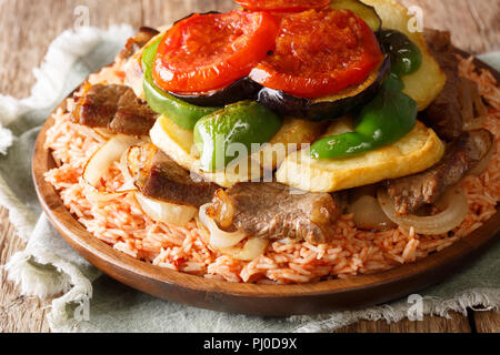 Homemade Iraqi food Makloubi rice with beef and vegetables close-up on a plate on the table. horizontal Stock Photo