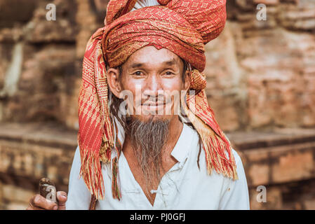 Nha Trang, Vietnam - May 5, 2018: a bearded man in a headscarf, a visitor of Cham people Po Nagar Temple celebration. Stock Photo