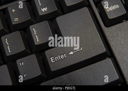 Black computer keyboard close-up. Focused on 'Enter' key. Stock Photo