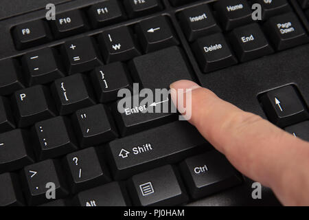 Black computer keyboard close-up. Focused on 'Enter' key. Stock Photo