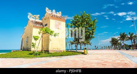 Da Nang, Vietnam - May 7, 2018: an old temple on the seafront sidewalk against blue sky on My Khe Beach. Stock Photo