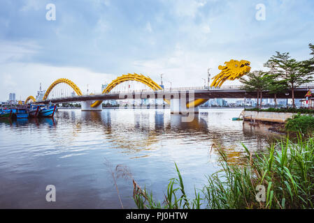 Da Nang, Vietnam - May 7, 2018: Dragon Bridge against the overcast sky, view from an embankment. Stock Photo