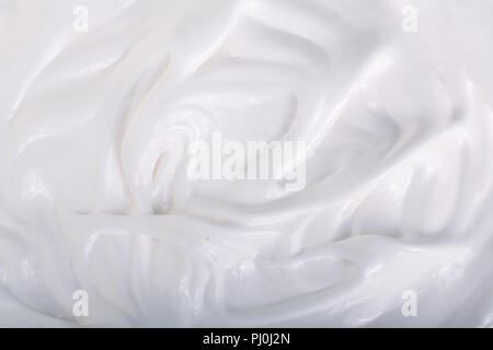 close up of a white whipped or sour cream on white background. Stock Photo