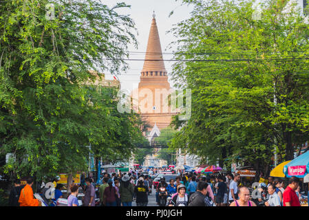 Nakhon Pathom, Thailand - Nakhon Pathom Chedi (Phra Pathommachedi) in the end of crowded Rotfai Street. Stock Photo