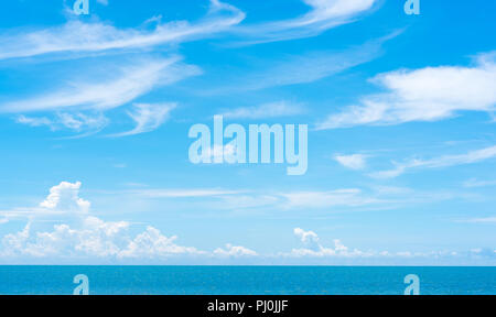 Vast sky space with summer clouds above the stripe of the sea with the horizon. Stock Photo