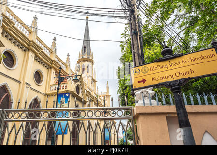 Holy Rosary Church (Kalawar Church) in Bangkok, Thailand, view from the street with a fence, wires & sign: Walking Street in Chinatown. Kalawar Church Stock Photo