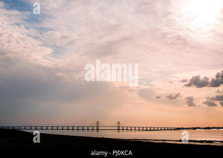 View of the Second Severn Crossing (Prince of Wales Bridge) from the English side (Old Passage, Aust) at low tide. Evening. Sunset. Summer. Stock Photo