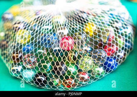 Colorful glass marbles in net Stock Photo