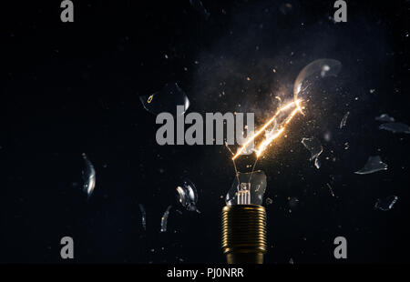 Freeze motion of old light bulb explosion on black backround. Concept of new idea and brain storming. Stock Photo