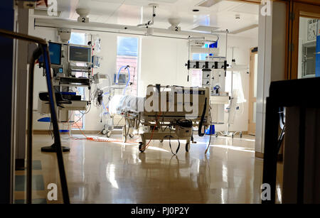 empty hospital bed in intensive critical care unit