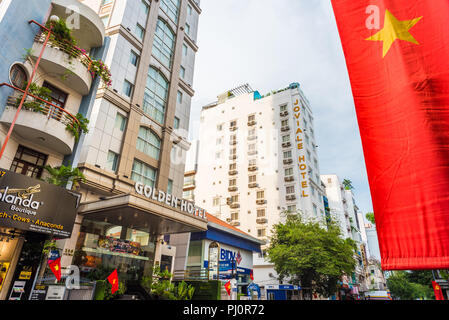 Ho Chi Minh City, Vietnam - April 29, 2018: 4-star Golden Central Hotel Saigon, Joviale Hotel & the flag of Vietnam in Ly Tu Trong Street, District 1 Stock Photo