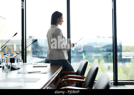 Businesswoman Alone in Conference Room Stock Photo