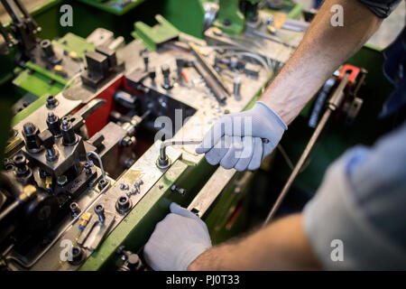 Working on machine Stock Photo