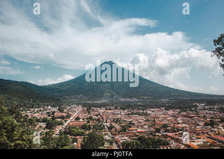 Aerial view of the city of Antigua Guatemala in summer, with volcano Acatenango in the distance Stock Photo