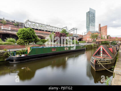 View along the Rochdale Canal from the Castlefield Basin in Manchester and looking towards the Hilton Hotel (Beetham Tower) and the railway bridge Stock Photo