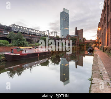 View along the Rochdale Canal from the Castlefield Basin in Manchester and looking towards the Hilton Hotel (Beetham Tower) and the railway bridge Stock Photo