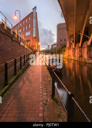 Portrait view from the towpath beside the Rochdale Canal at night, looking back towards the Castlefield Basin Stock Photo