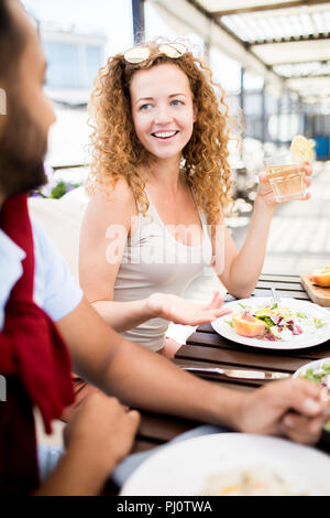 Woman Talking to Friend in Cafe Stock Photo