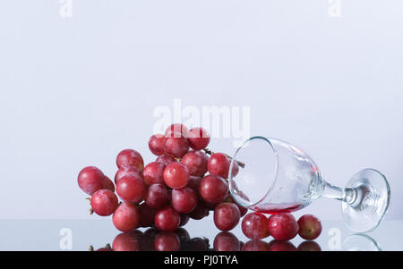 grape vine on white background, juice vine in glass, falling glass with wine, Stock Photo