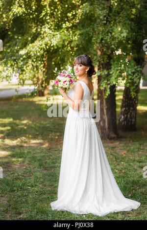 beautiful smiling bride in wedding white dress Stock Photo