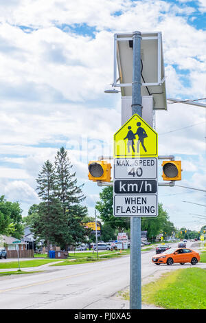 School zone speed warning sign on a busy street. Stock Photo