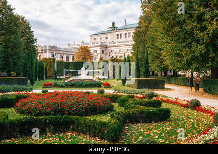 Vienna, Austria - 1 October, 2017: Seniors couple walks in the Volksgarten People's Garden public park with museum of natural history on background in Stock Photo