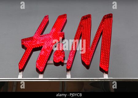 Copenhagen, Denmark - August 26, 2018: H & M logo on a facade. H & M is a swedish multinational retail clothing company, Stock Photo